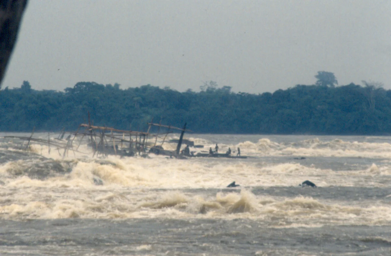 The Boyoma Falls rapids/cataracts of the Lualaba River — near Kisangani, in the Democratic Republic of the Congo.
The Wagenya peoples are indigenous fishermen who have developed a unique technique to fish in the river. They build a huge system of wooden tripods across the river. These tripods are anchored on the holes naturally carved in the rock by the water current. To these tripods are anchored large baskets, which are lowered in the rapids to “sieve” the waters for fish. It is a very selective fishing method, as these baskets are quite big and only large fish are entrapped.